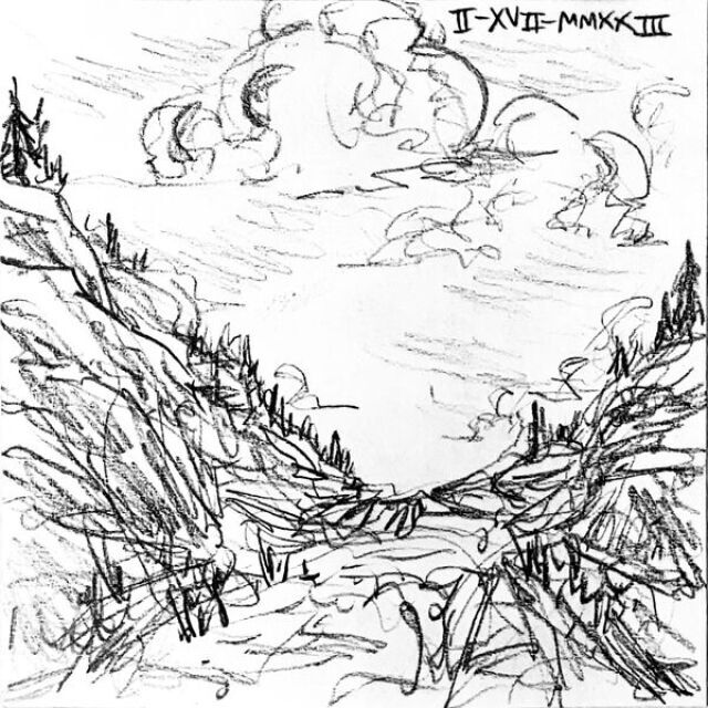 Fat clouds roll above a barren, narrow valley with trees on the valley's edge.